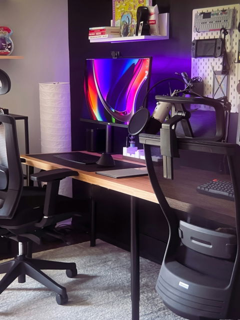 black office rolling chair beside brown wooden table